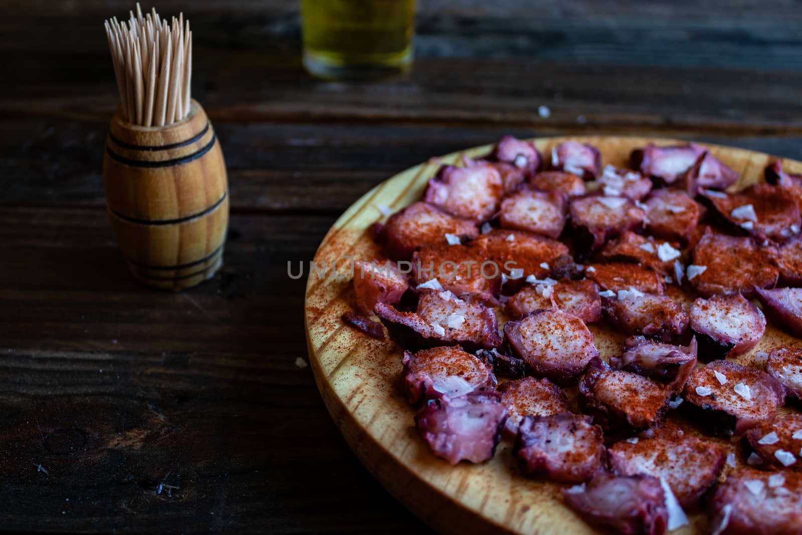View of Galician octopus dish on old wooden background