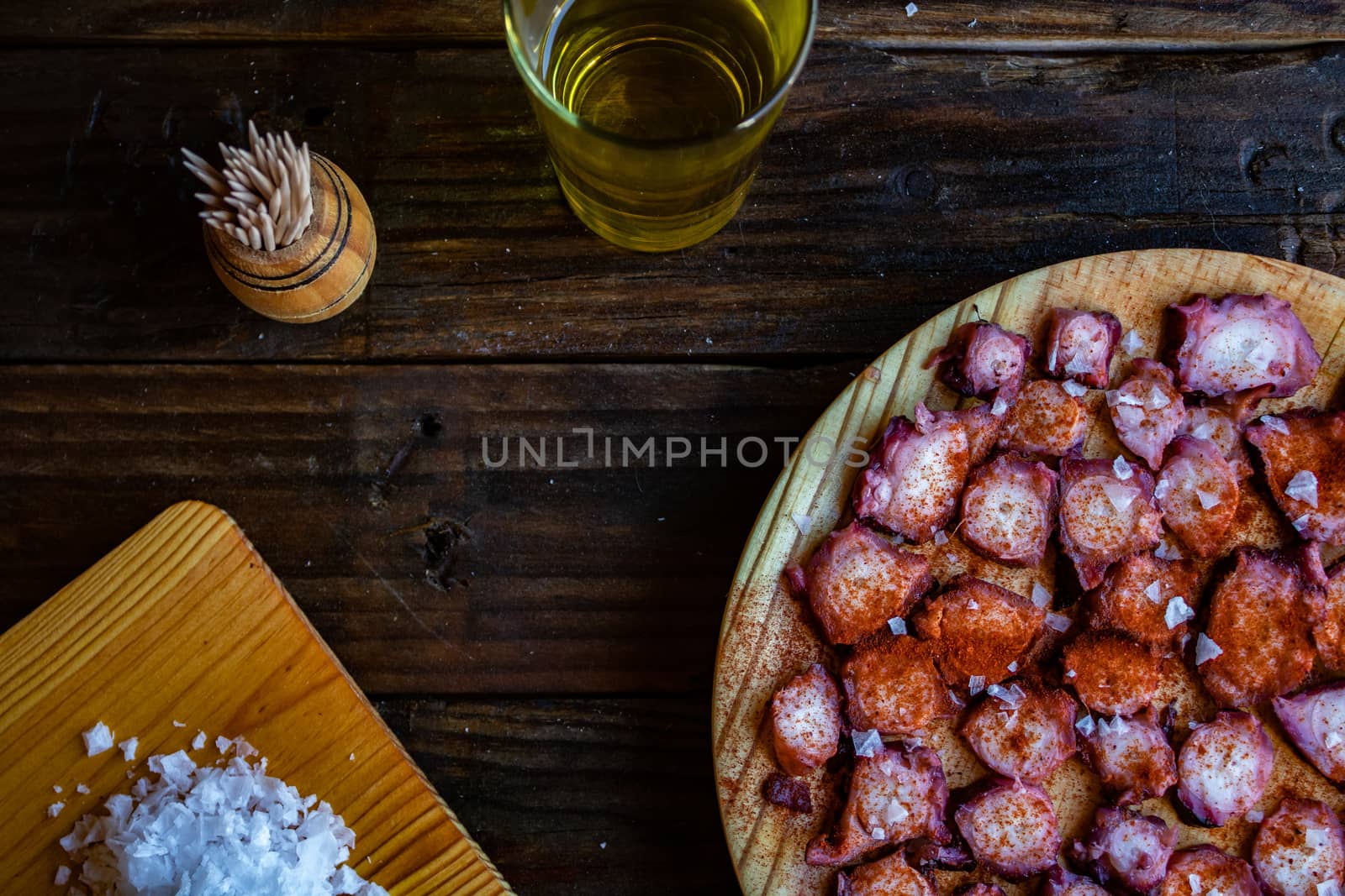 View of Galician octopus dish on old wooden background