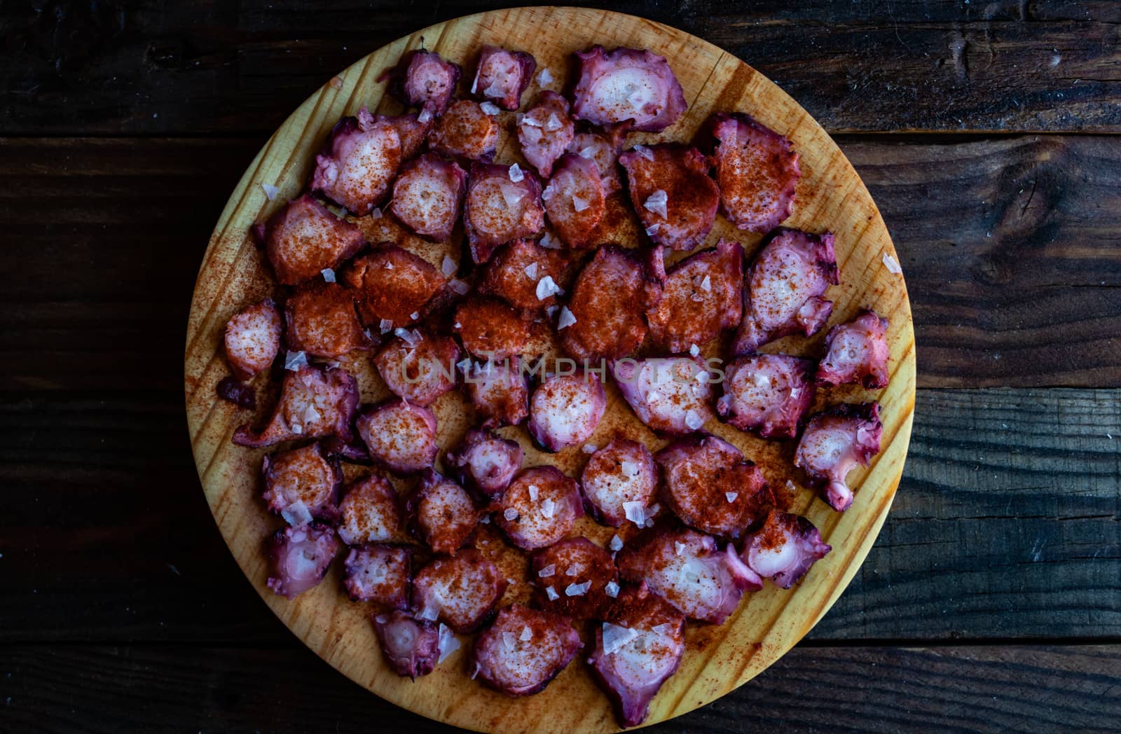 View of Galician octopus dish on old wooden background