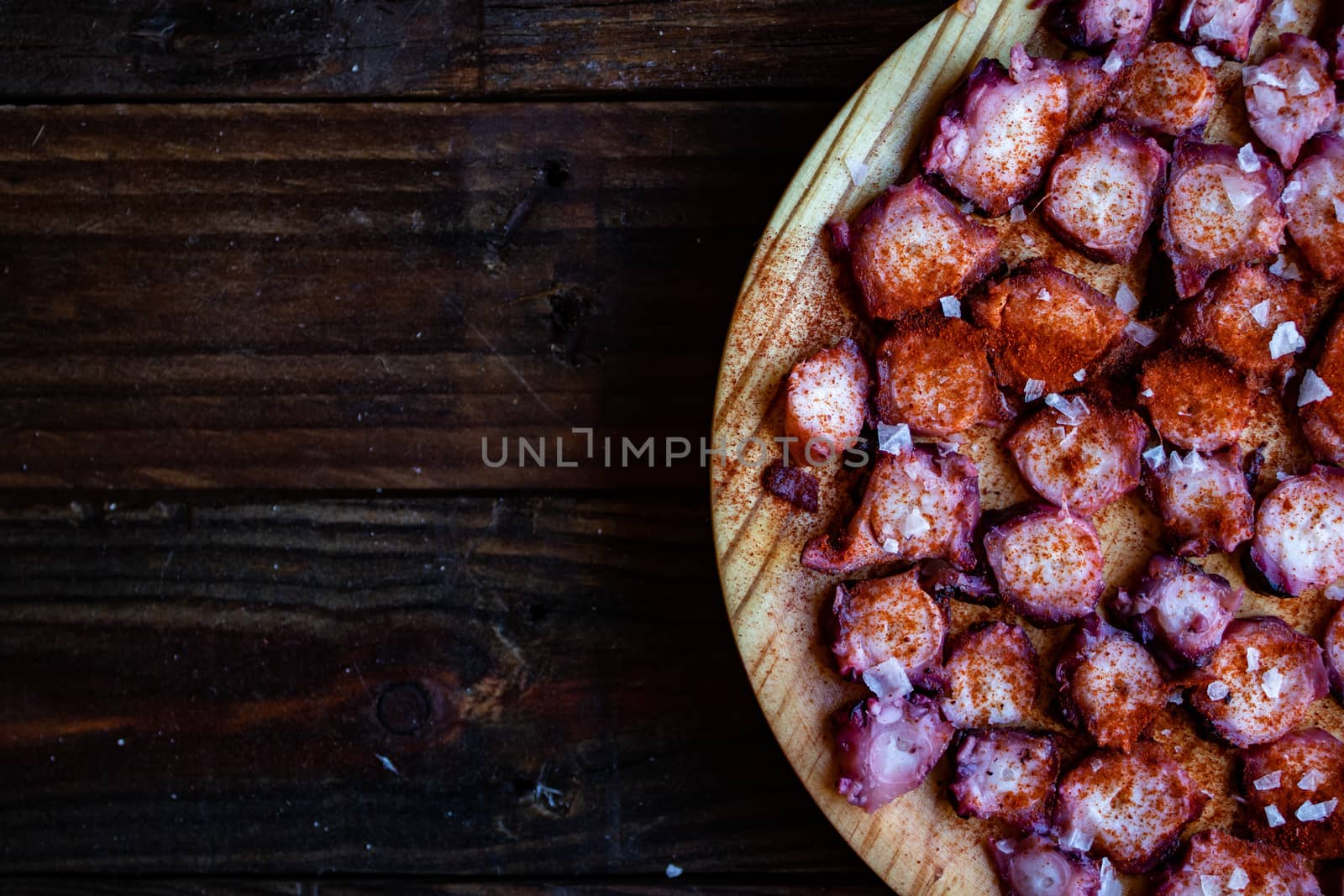View of Galician octopus dish on old wooden background