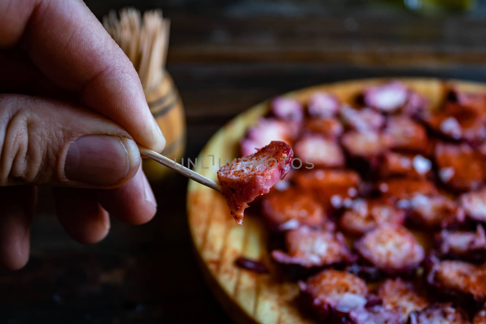 View of Galician octopus dish on old wooden background
