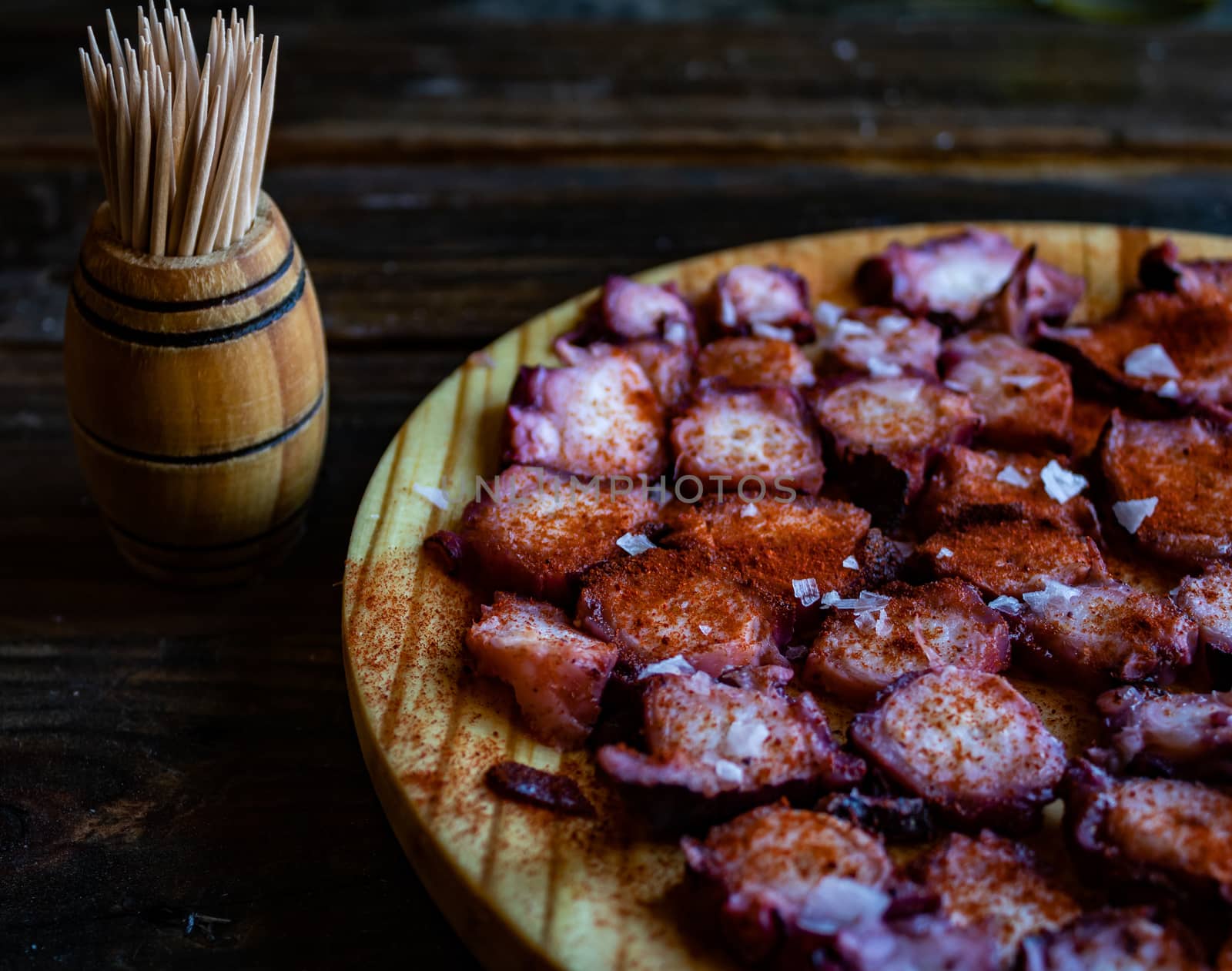 View of Galician octopus dish on old wooden background