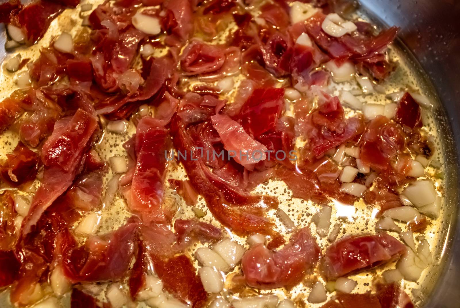 Stir fried garlic and ham in olive oil