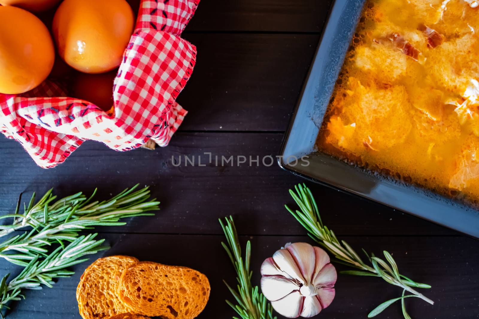 Typical Spanish garlic soups in composition on dark wood background