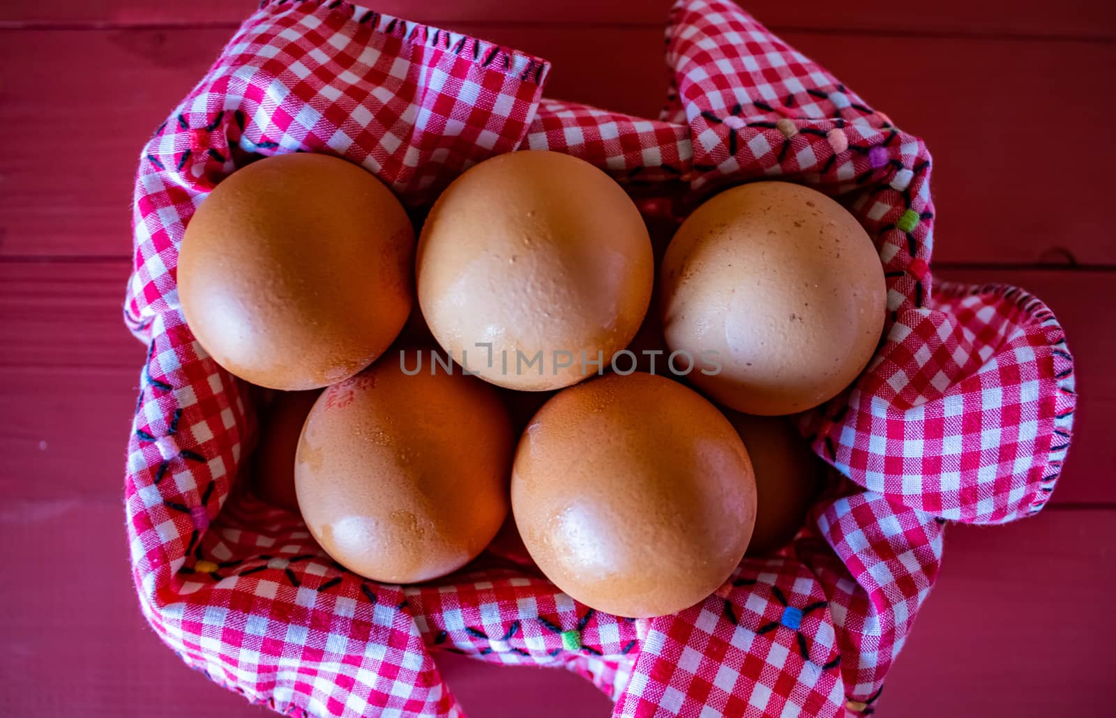View of egg basket with checkered tablecloth