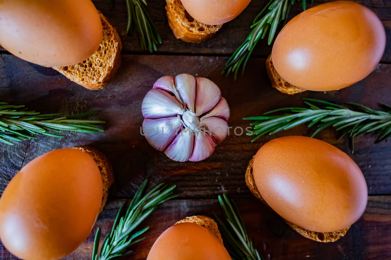 Ingredients for garlic soup in composition on wooden background
