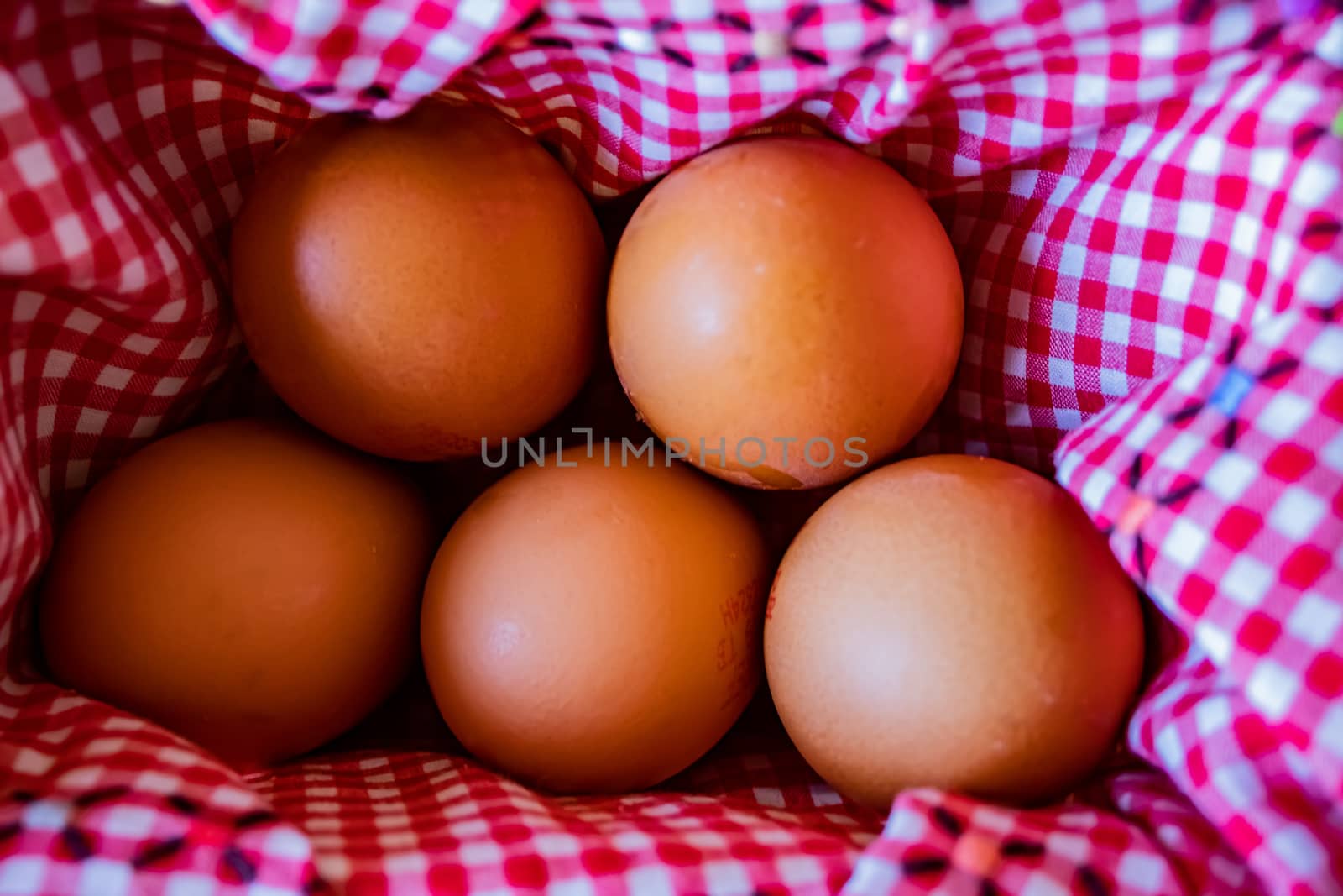 View of egg basket with checkered tablecloth