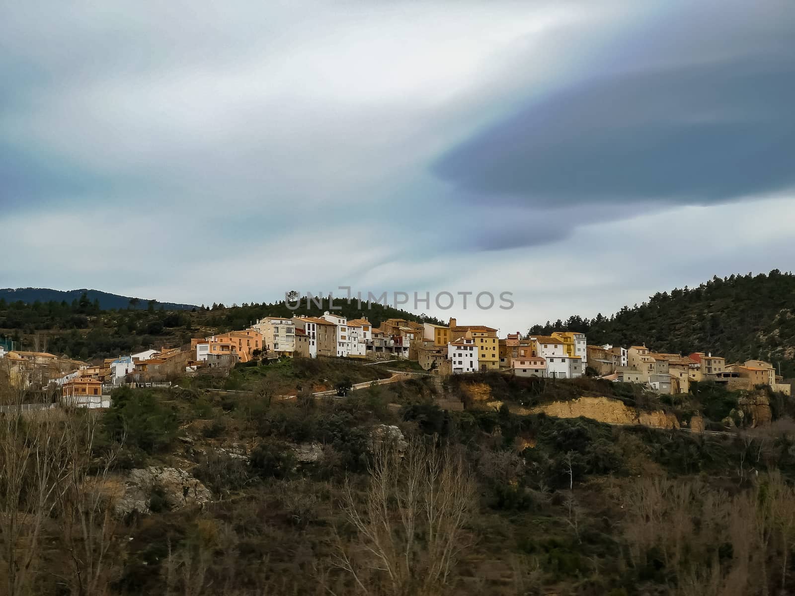 View of the mountain village of Fuente de la Reina with gray sky