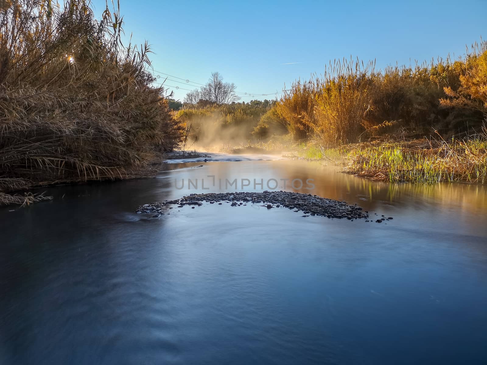 River with water evaporating on a very cold morning in the mountain