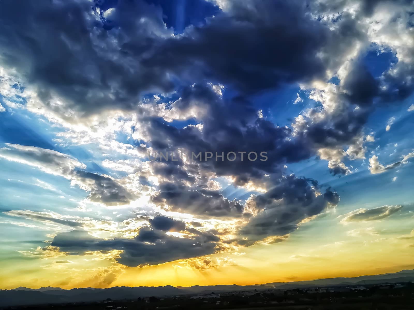 Sunset with threatening storm clouds over mountains