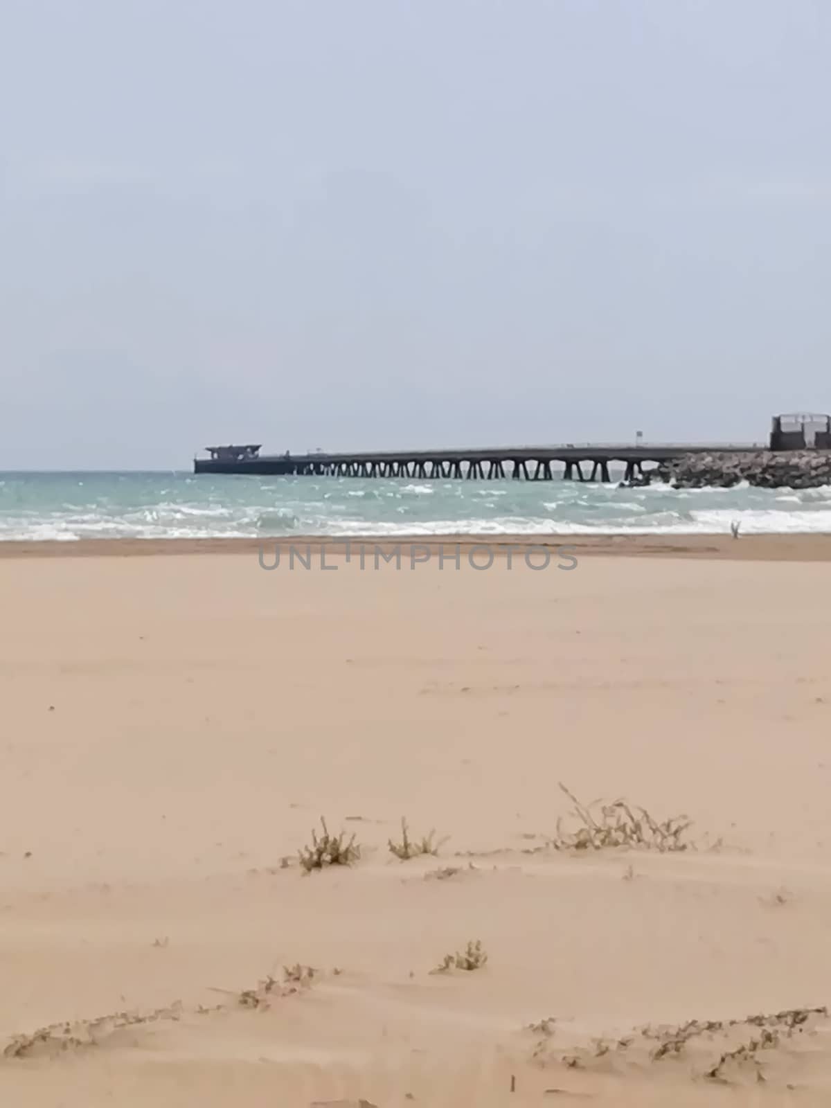 Beach of fine brown sand bathed by the waters of the Mediterranean Sea