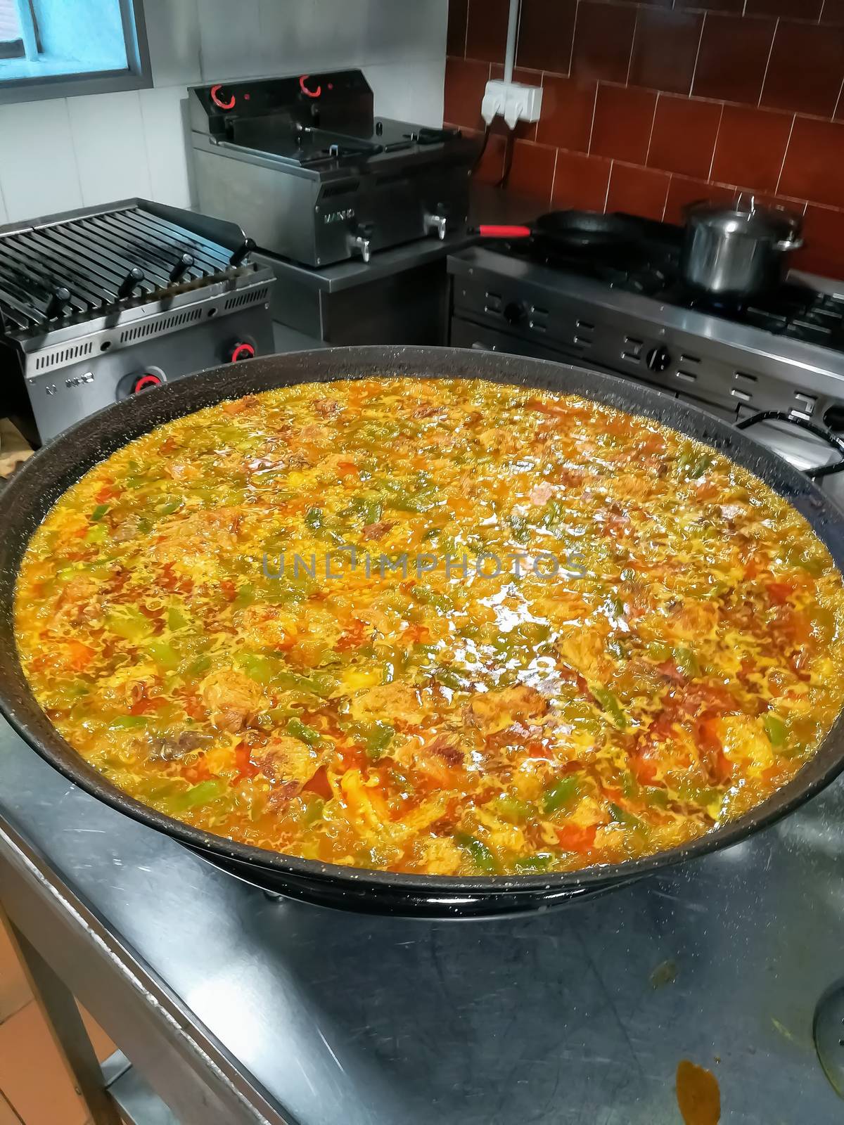 Typical Spanish food of rice, meat and vegetables in special flat casserole for this meal