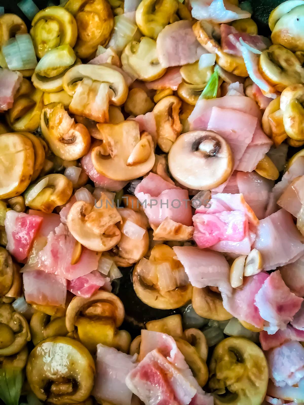 Ariel view of food in preparation with mushroom, bacon and onion