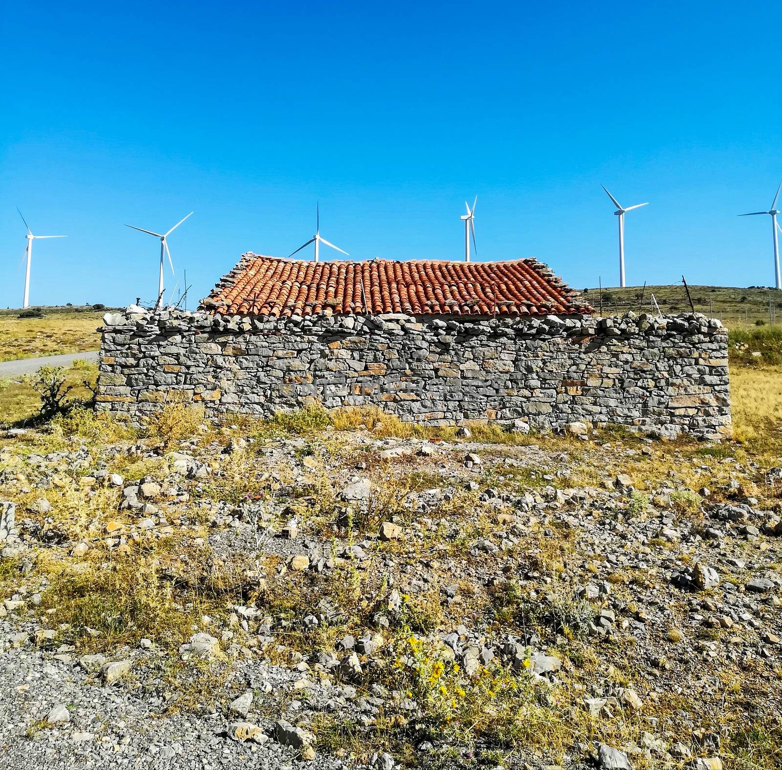 Wind generators on the mountain with blue sky in the background