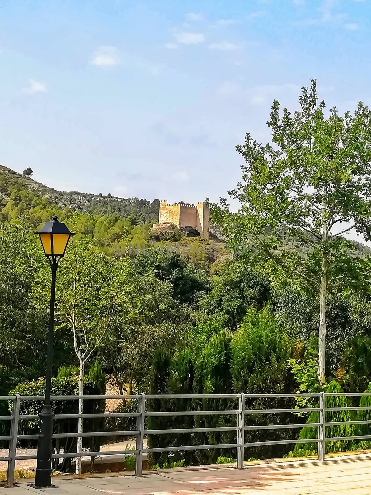 View of the ancient castle of Gaibiel with the forest below and the cloudy sky