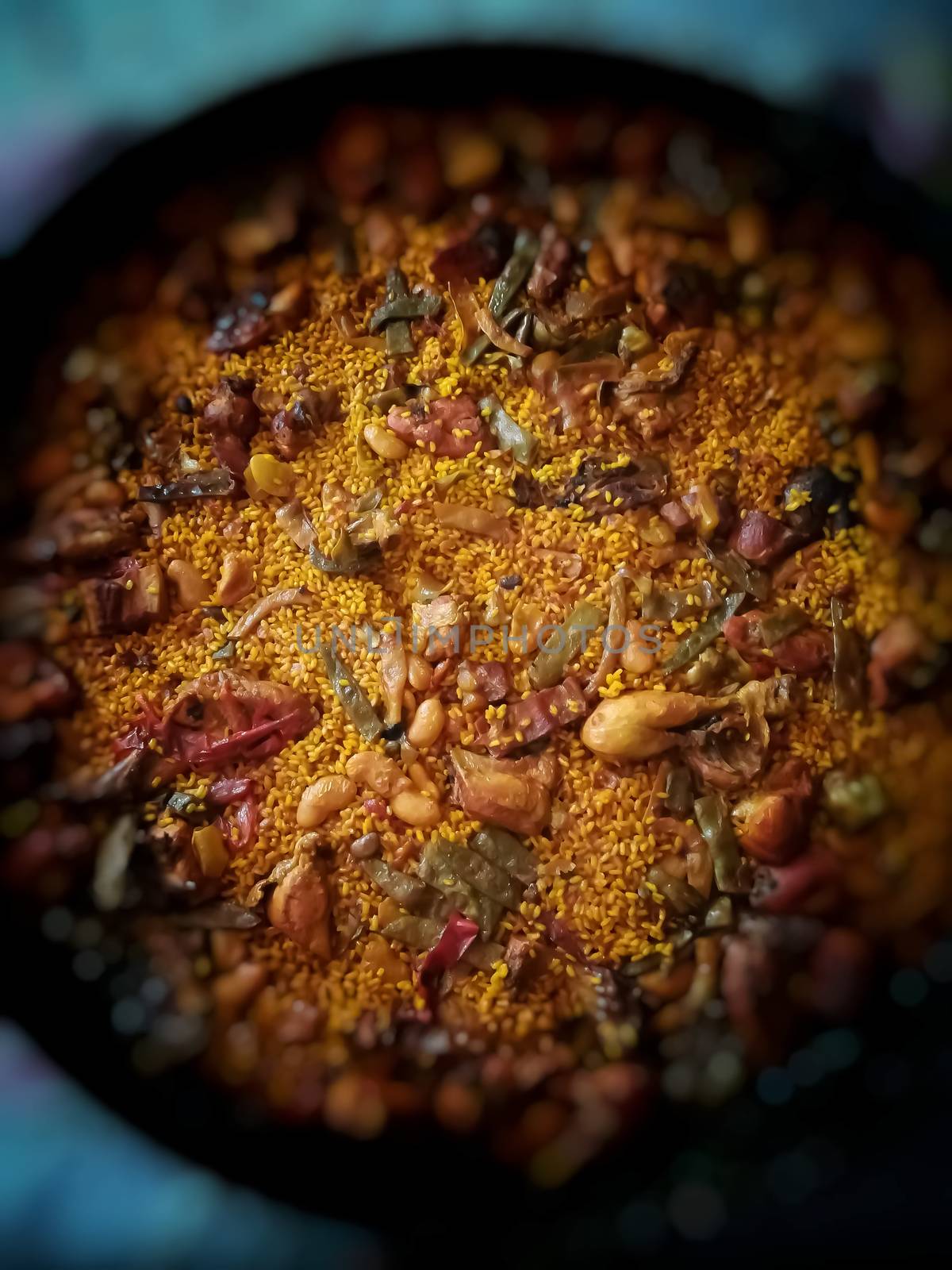 Typical Spanish food of rice, meat and vegetables in special flat casserole for this meal