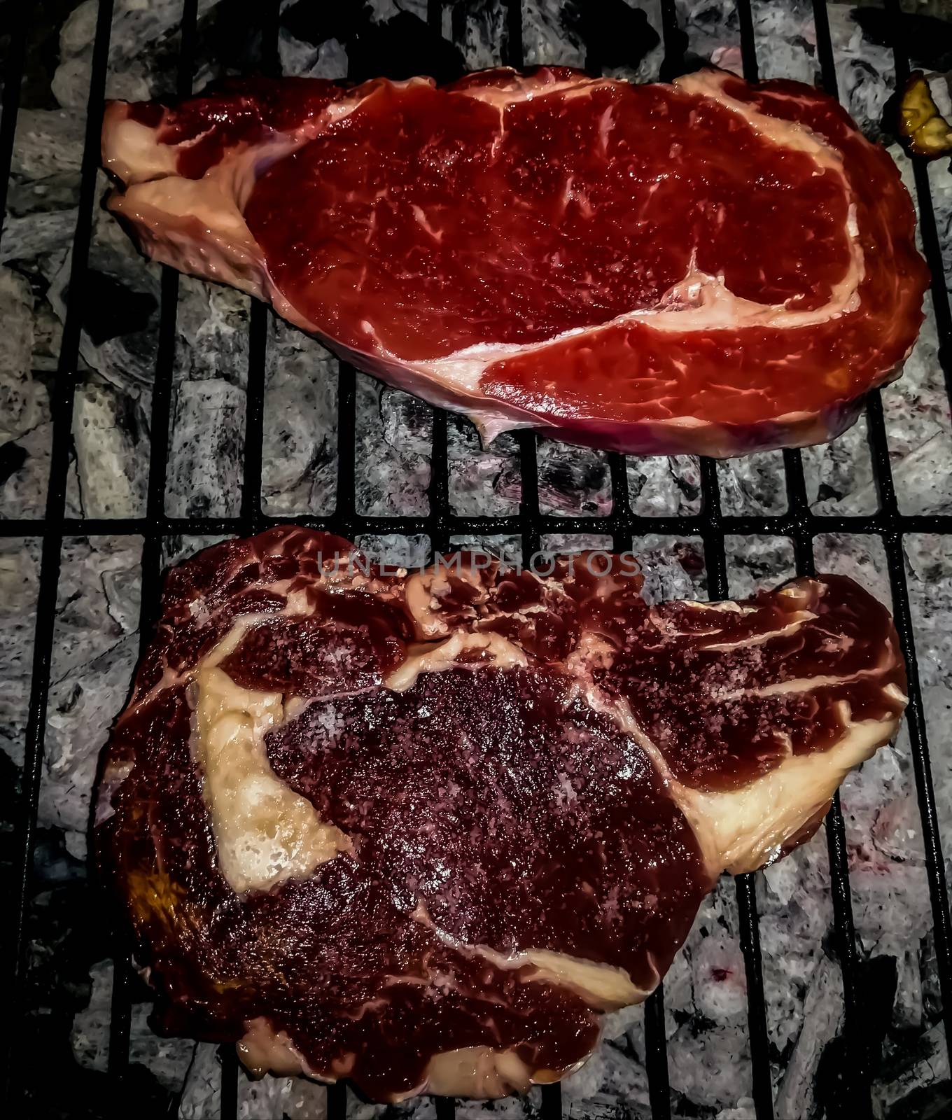 Barbecue with two veal steaks with different tones