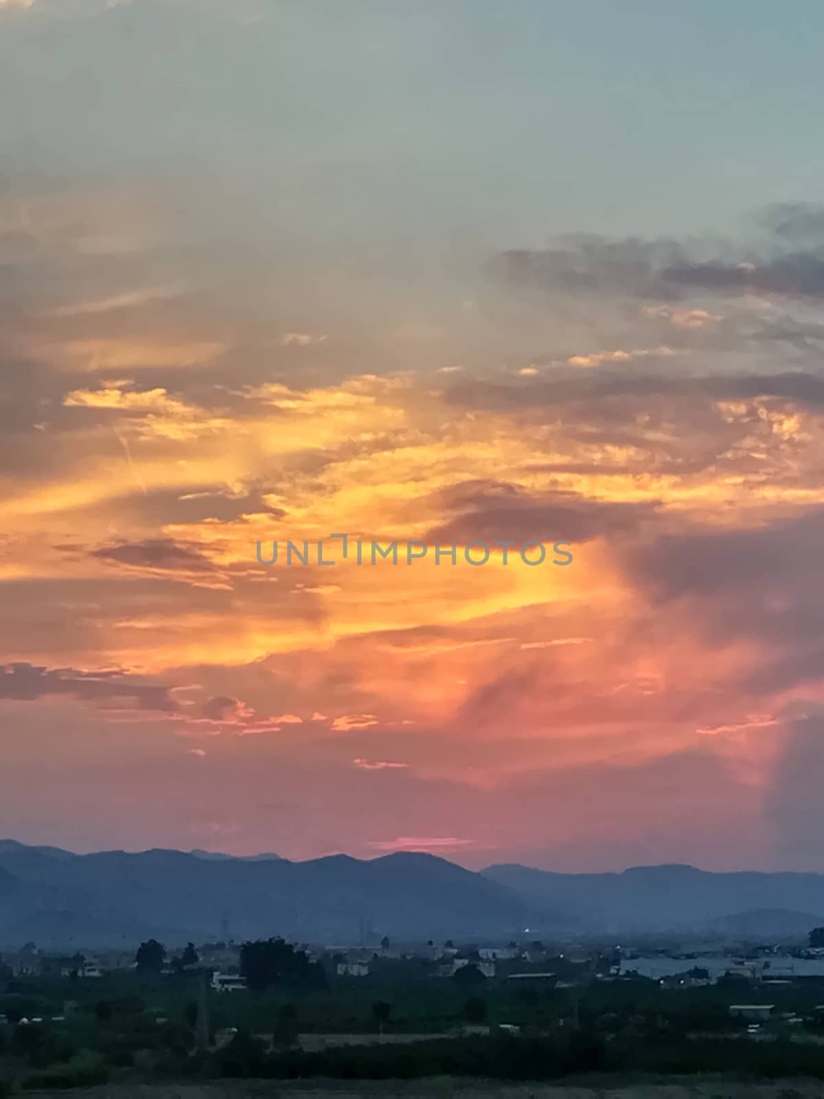 Sunset with threatening storm clouds over mountains
