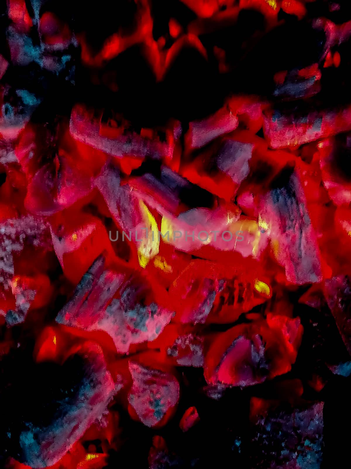 Incandescent coals in reddish, orange and yellow tones