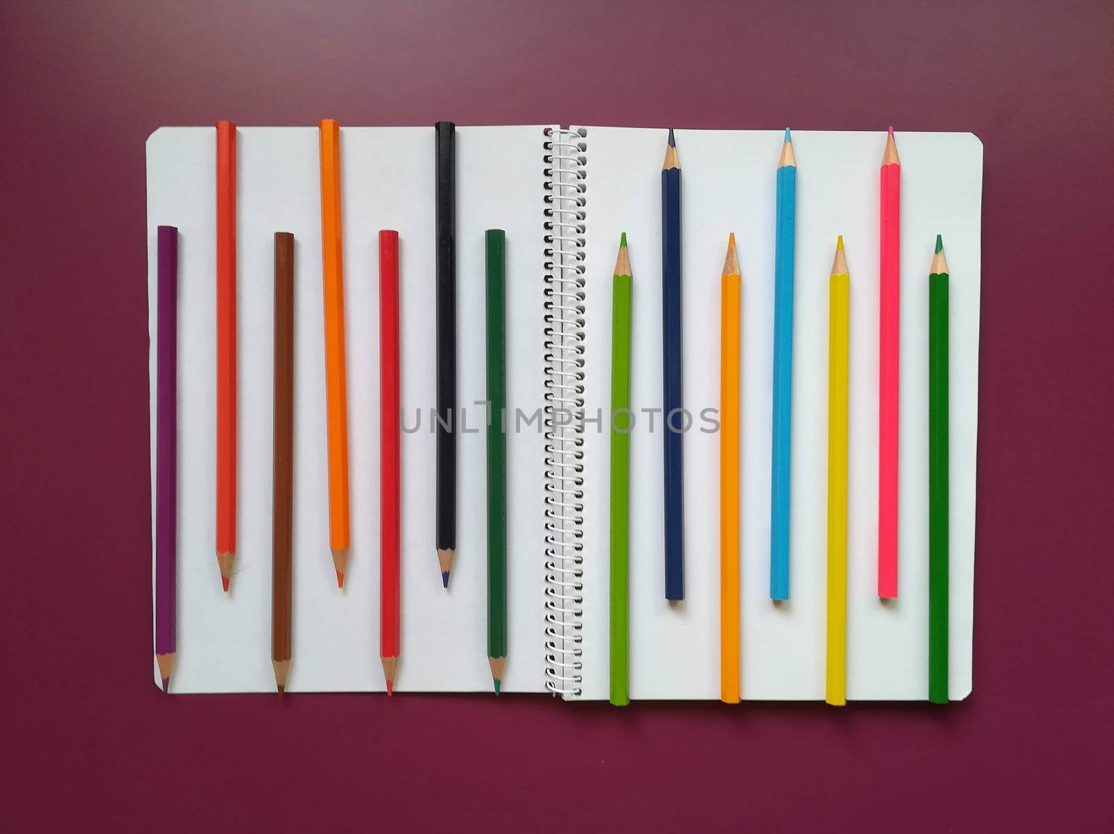 Various school material in composition on purple background