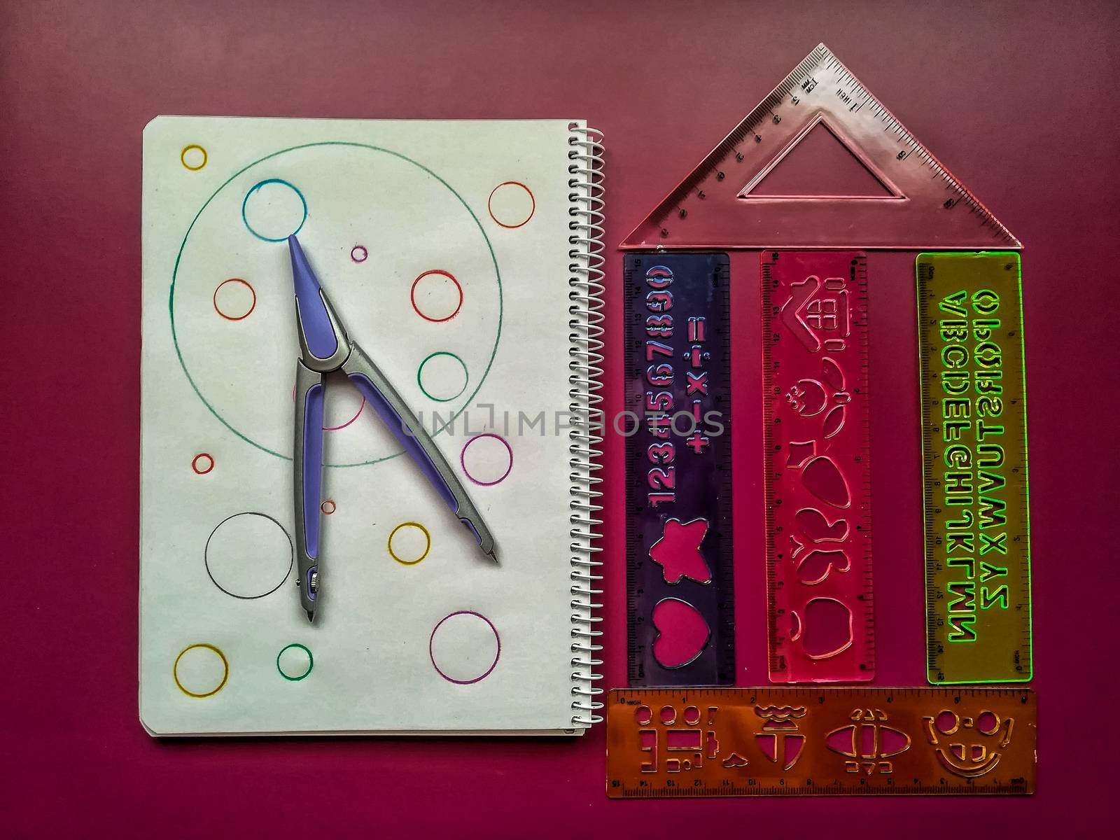 Various school material in composition on purple background