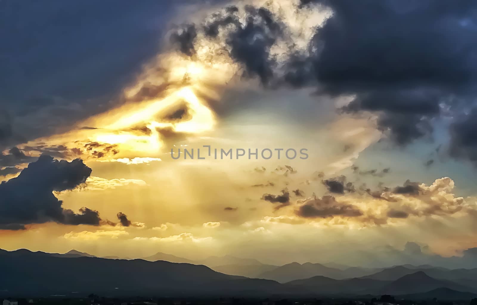 Sunset with threatening storm clouds over mountains