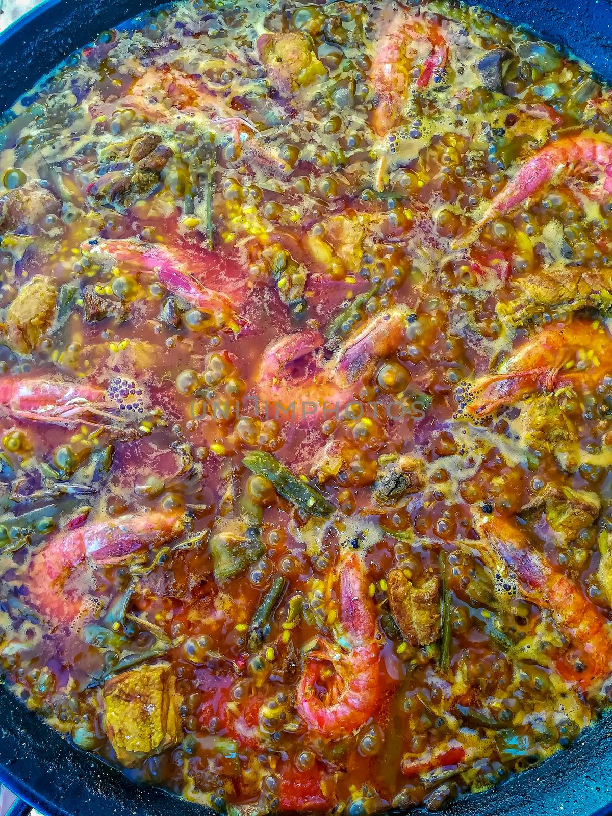 Typical Spanish food of rice, meat and vegetables in special flat casserole for this meal