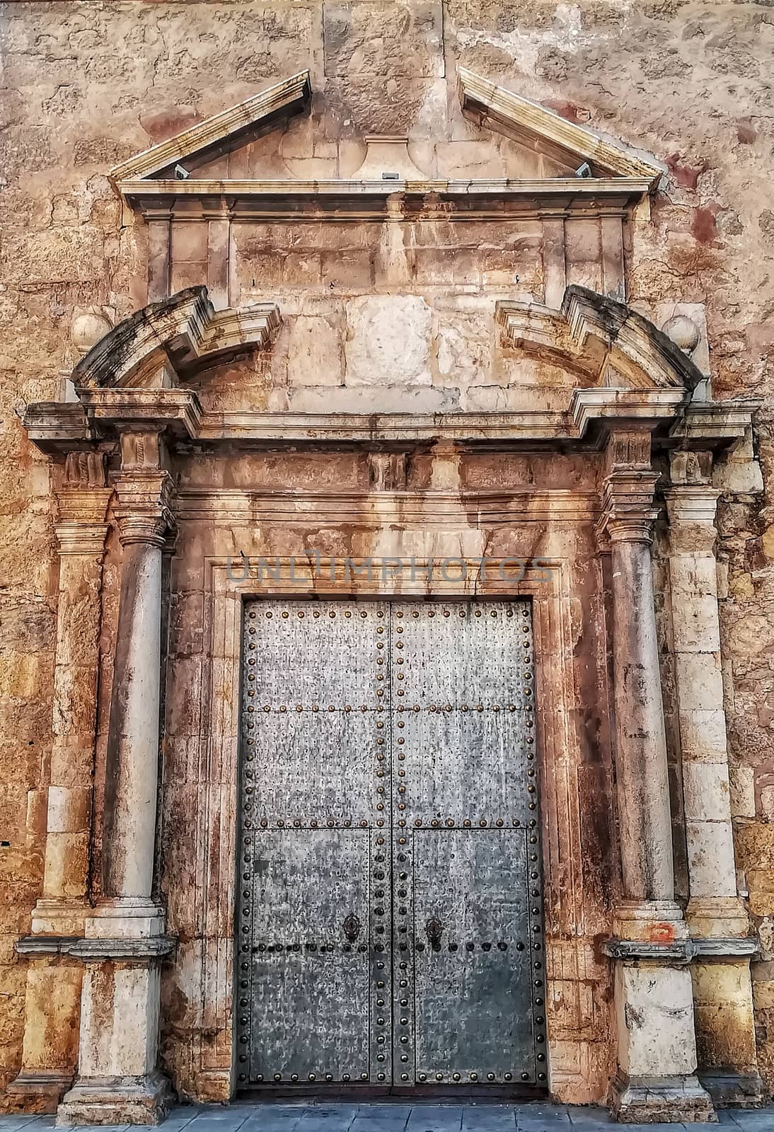 Old metal door with stone ornament in a church