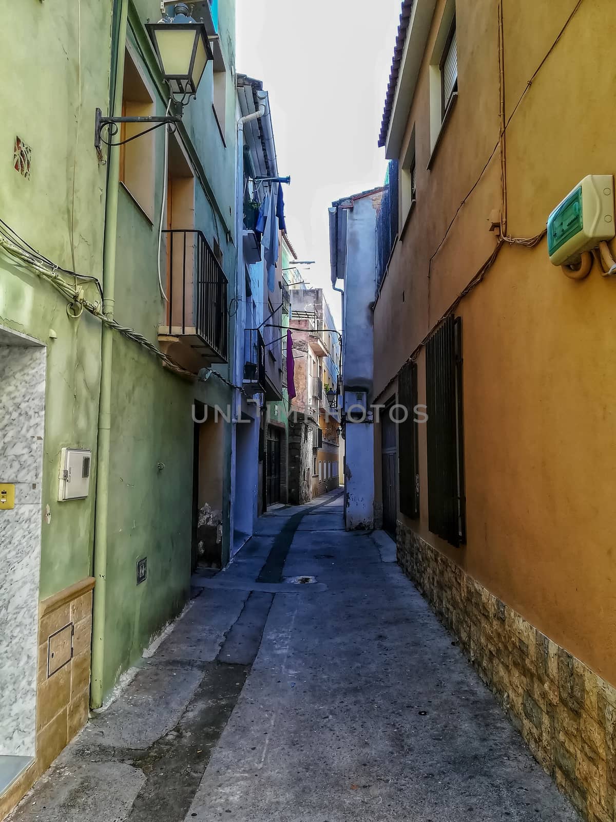 Beautiful little street with houses painted in different colors in the town of Navajas