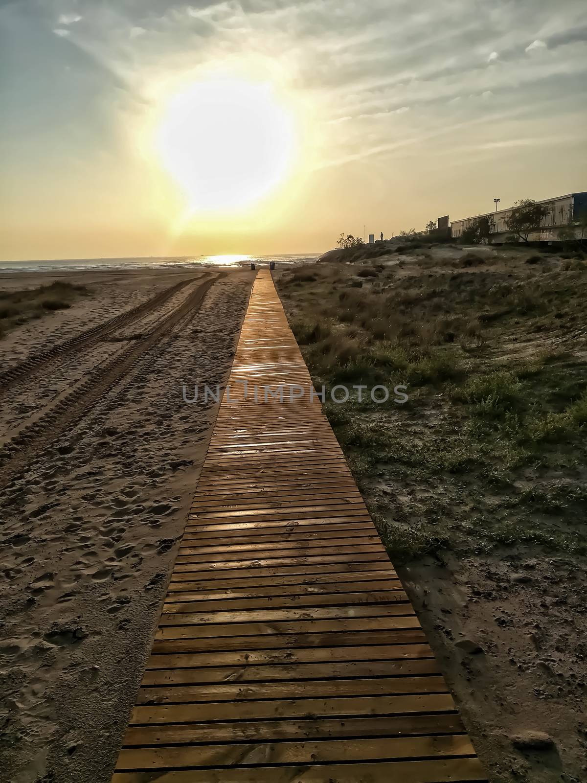 Wooden walkway to access the beach with the Mediterranean Sea in the background