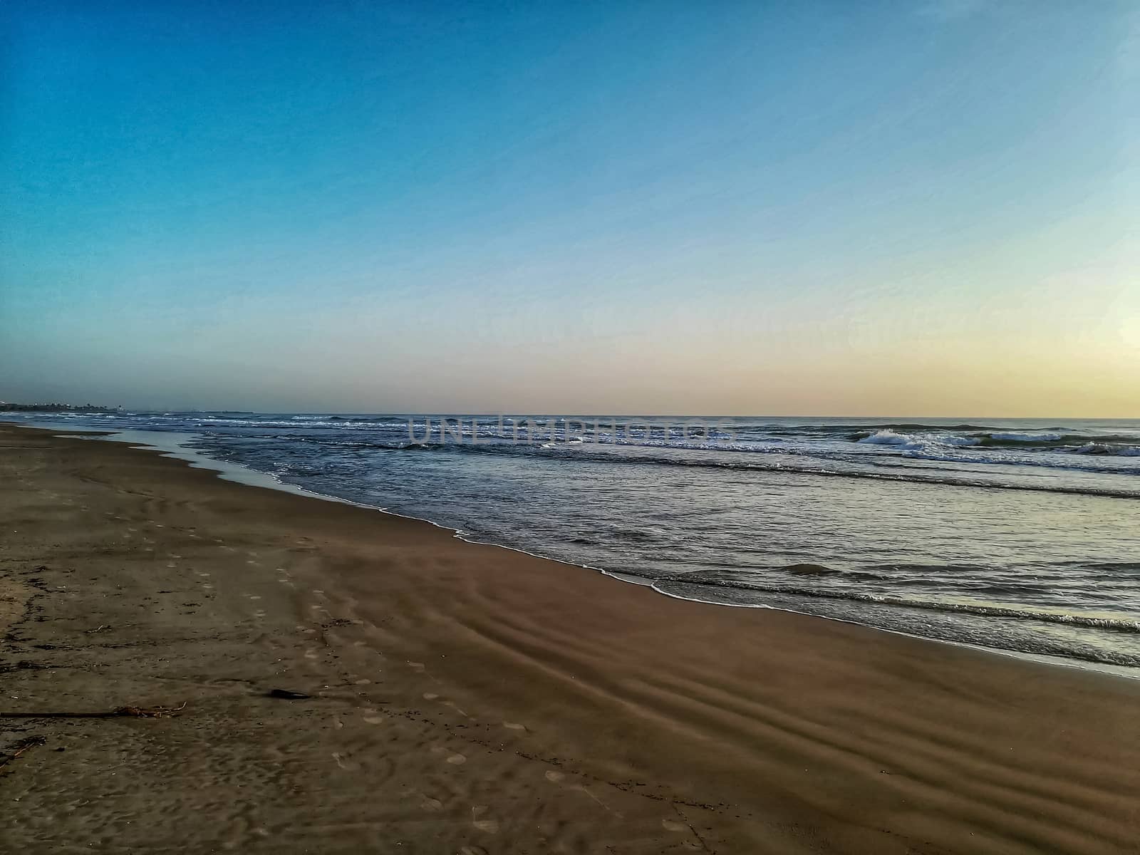 Beach of fine brown sand bathed by the waters of the Mediterranean Sea