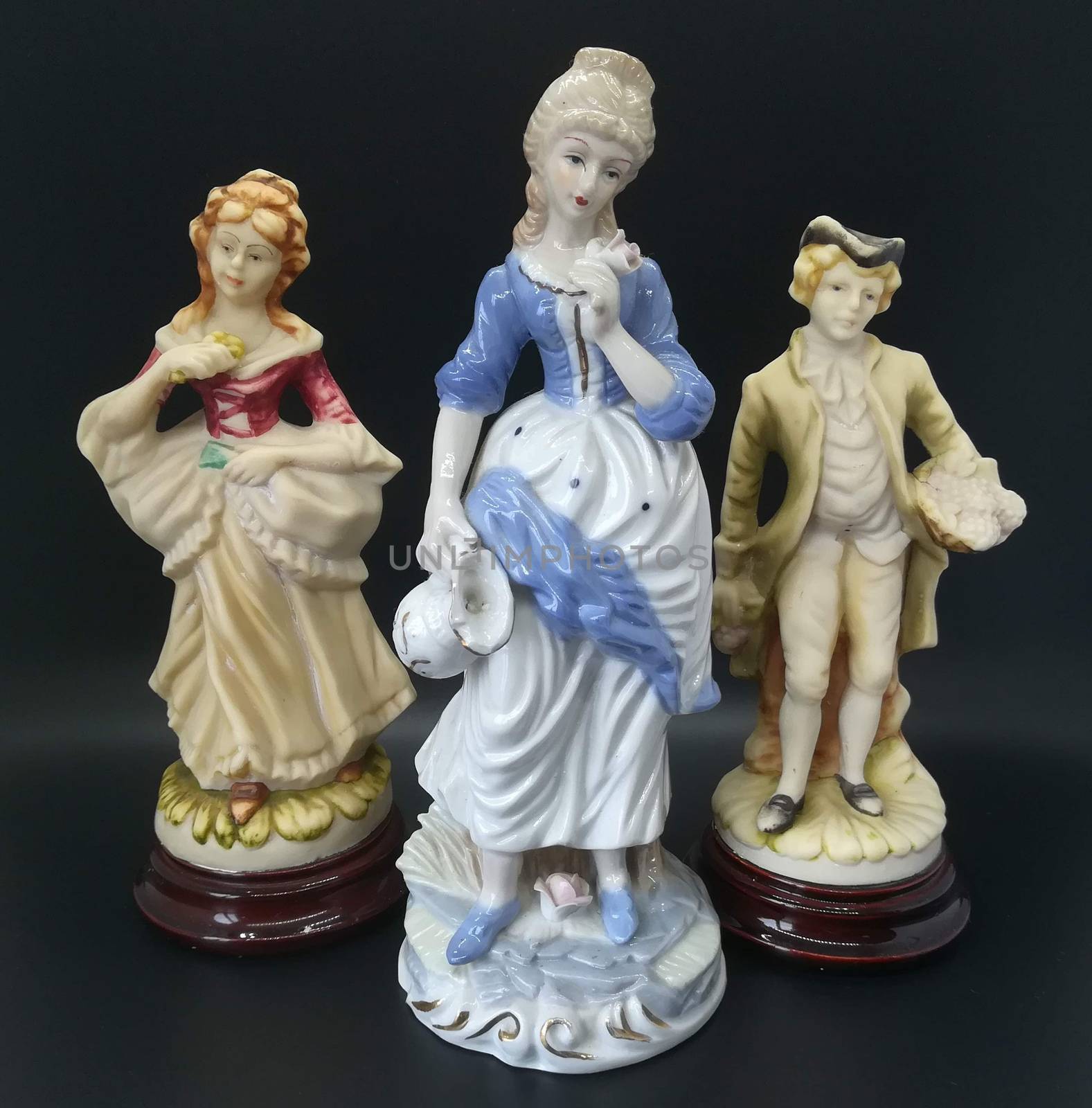 Ceramic figures of people on black background