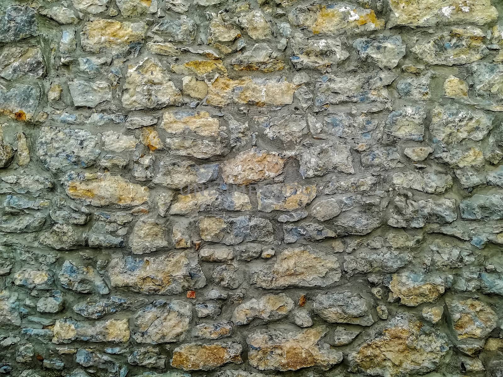 Facade of natural stone and gray cement