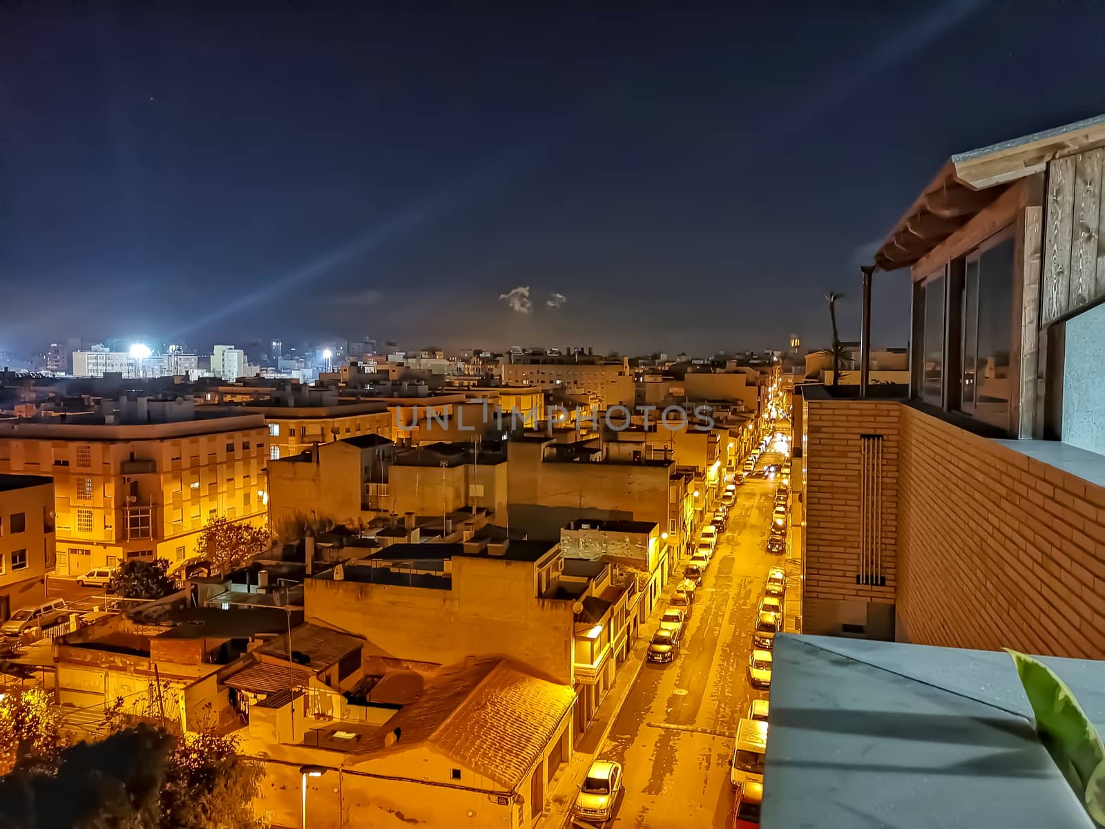 Night view of the town of Burriana with the lights of the San Fernando Stadium in the background