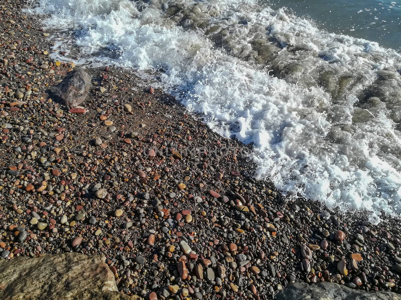 Small stone beach bathed by the waters of the Mediterranean Sea