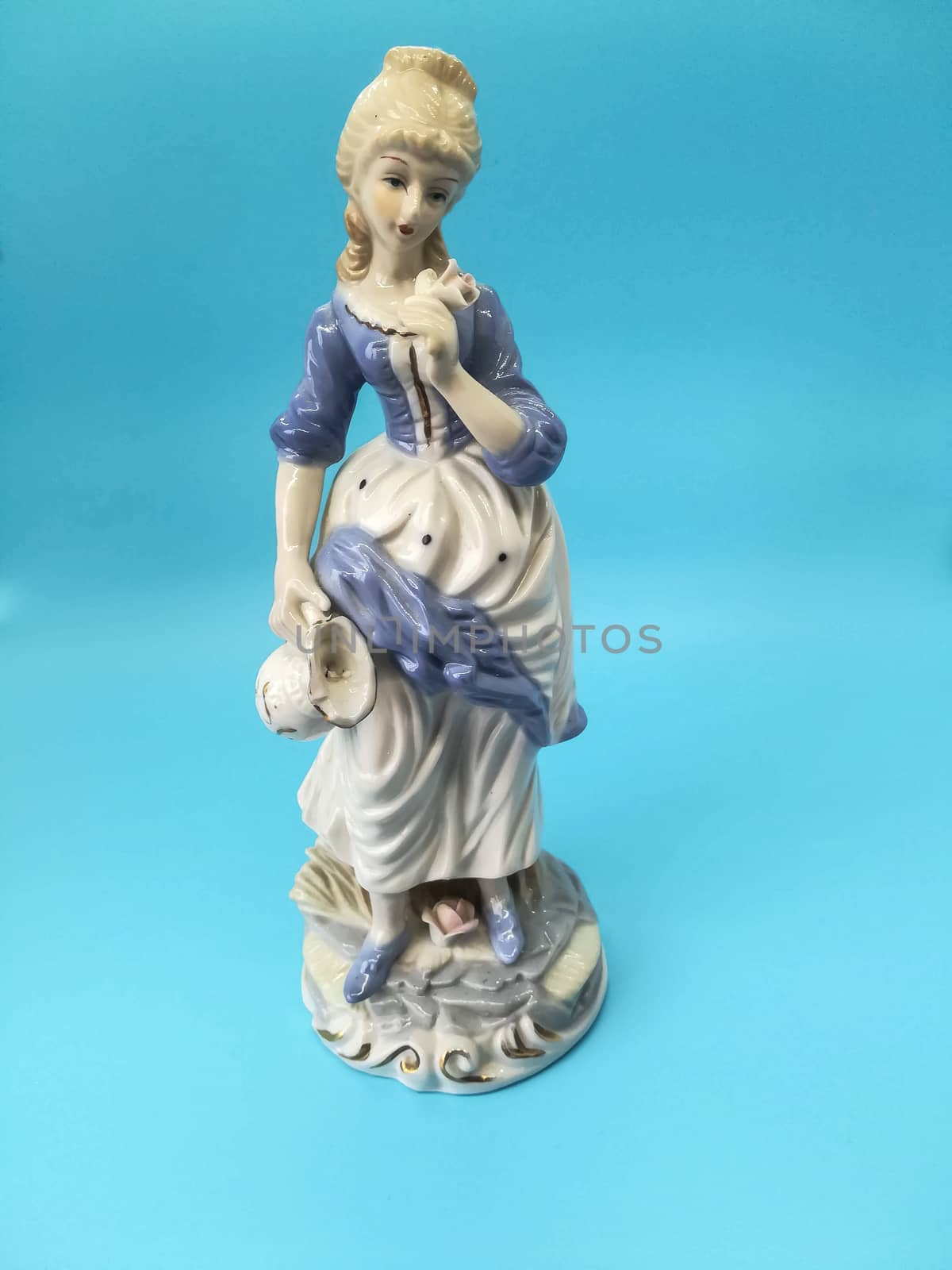 Ceramic figures of people on blue background