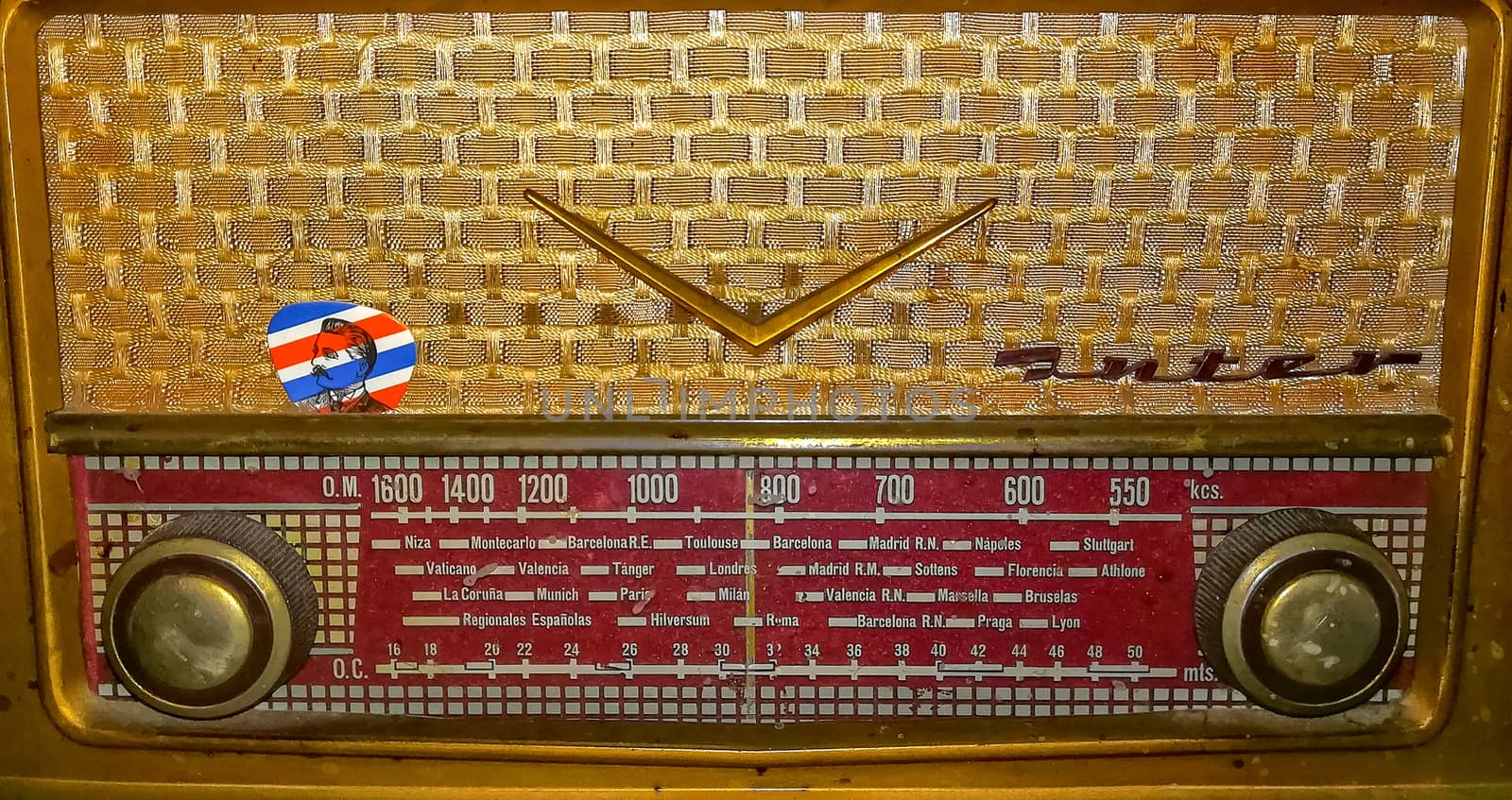 View of old golden radio with red control panel
