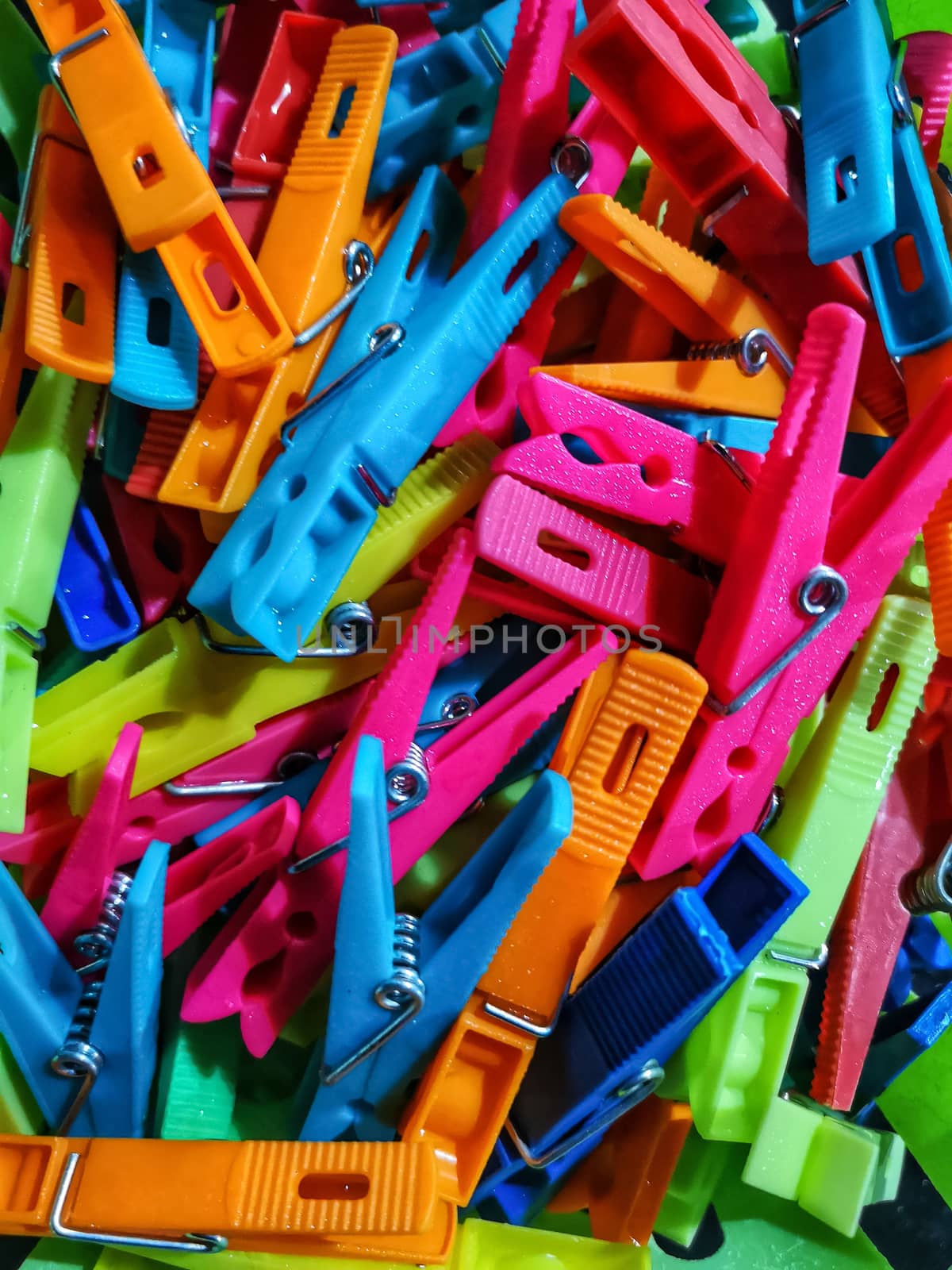 Colorful clothespins with dew water