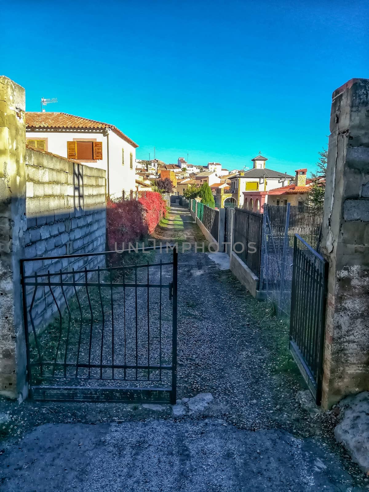 Old metal access door to an unpaved street
