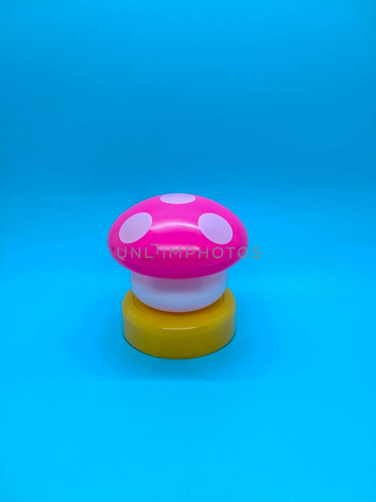 Toy mushroom shaped lamp on a blue background