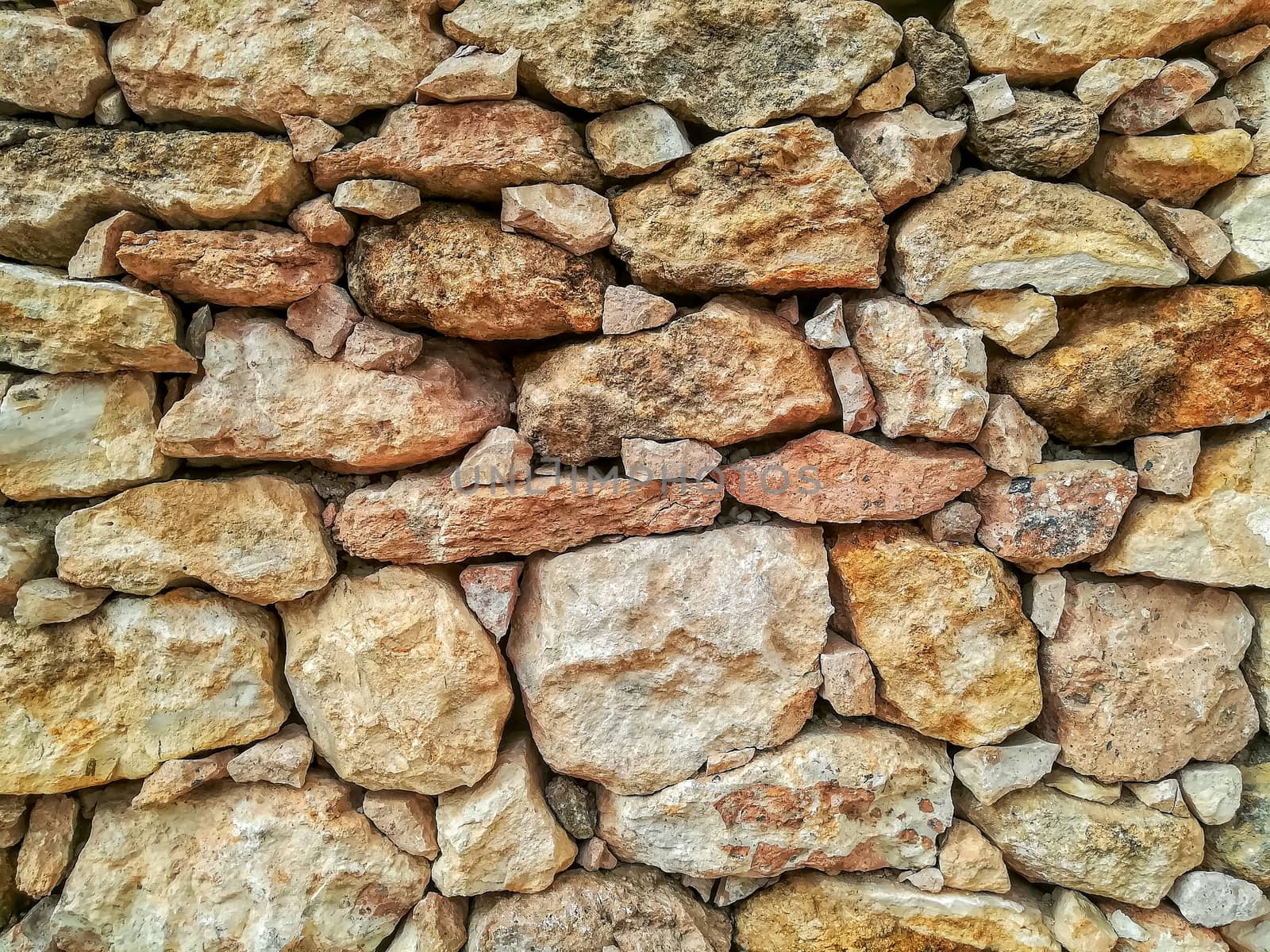 Brown stone wall built manually without the help of cement