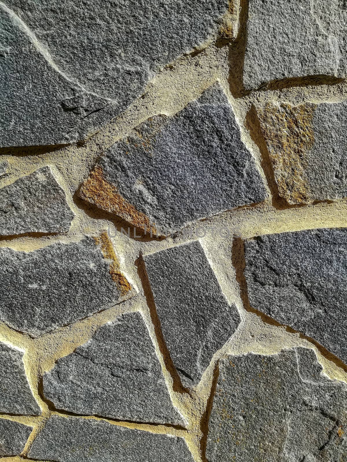 Facade of natural stone and gray cement