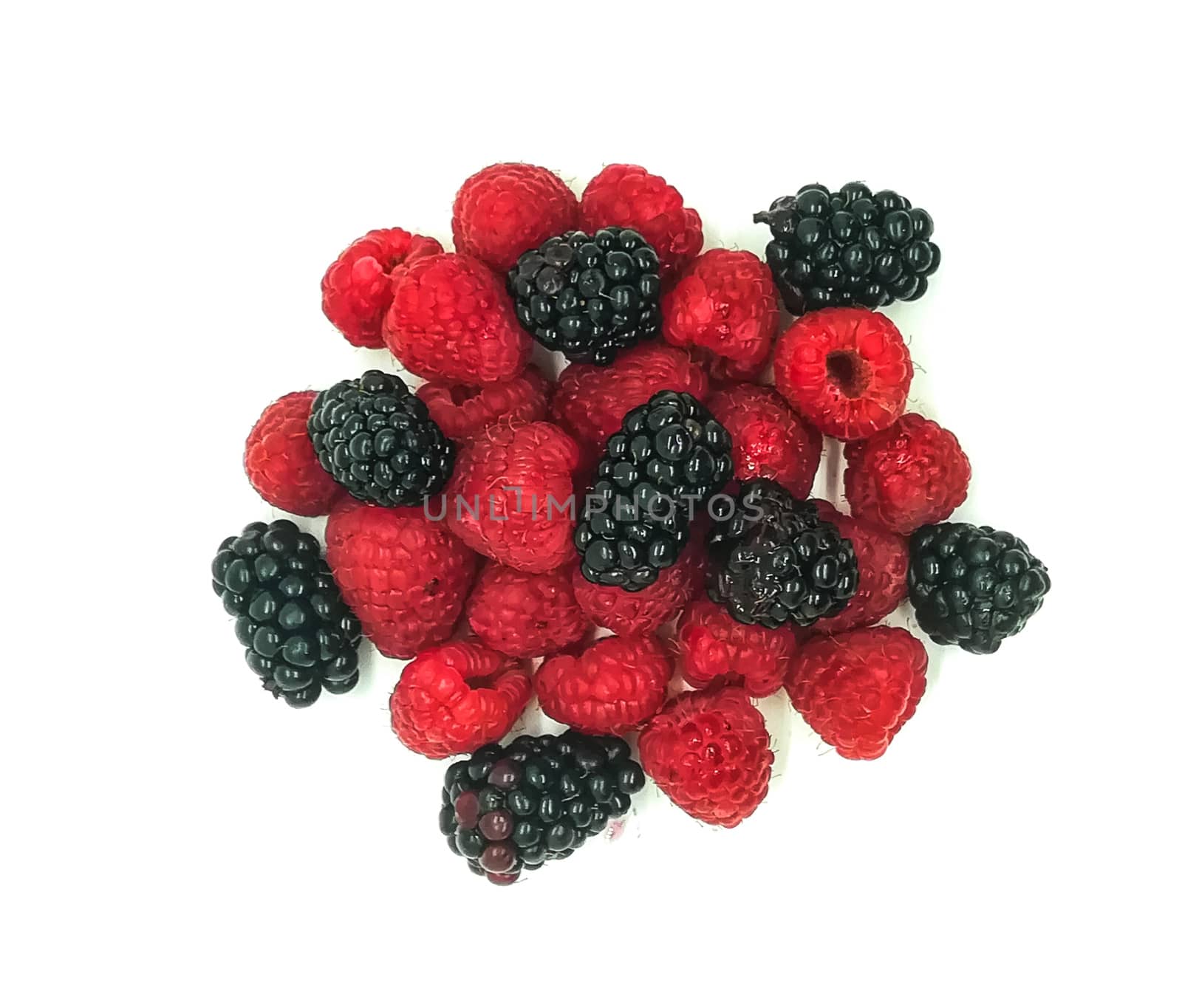 blackberries and raspberries in composition on white background