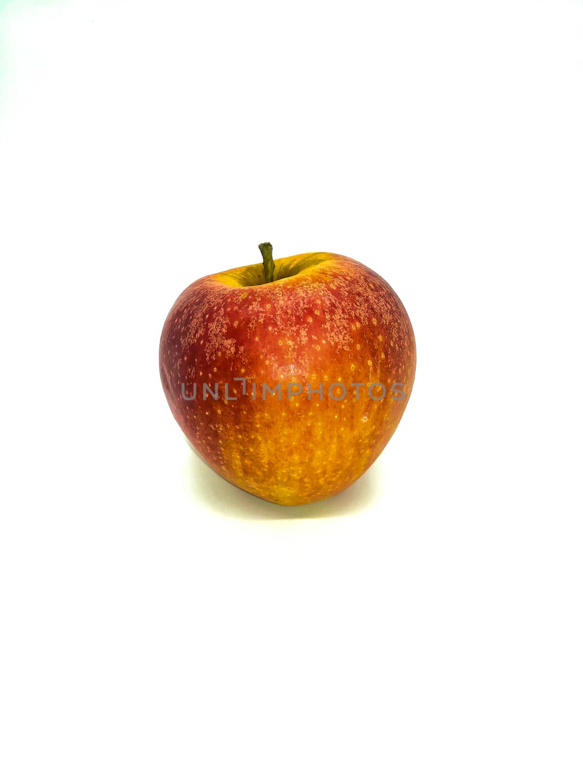 Red apple with yellow speckles on white background