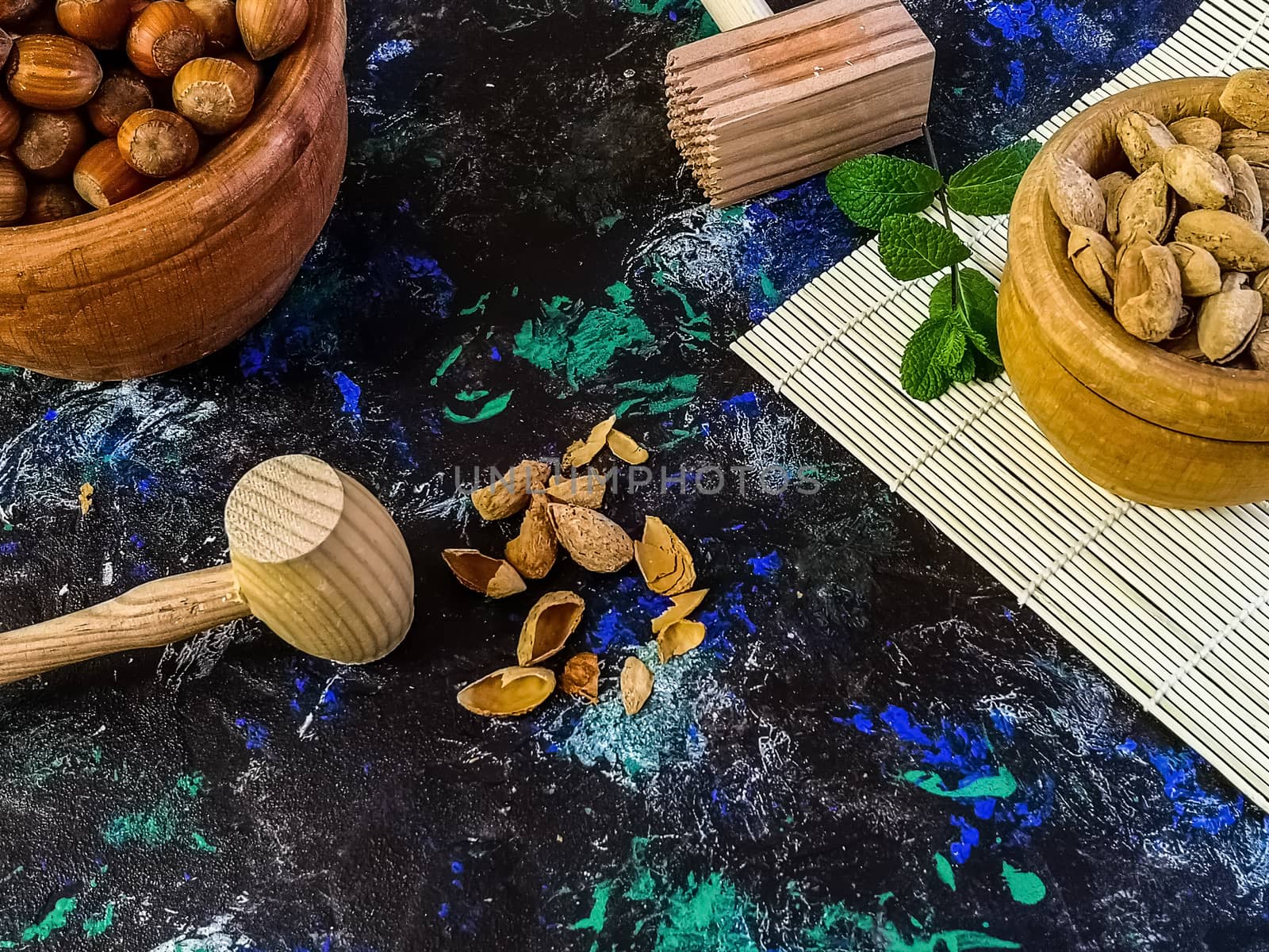 Walnuts and hazelnuts in composition on dark and rough background