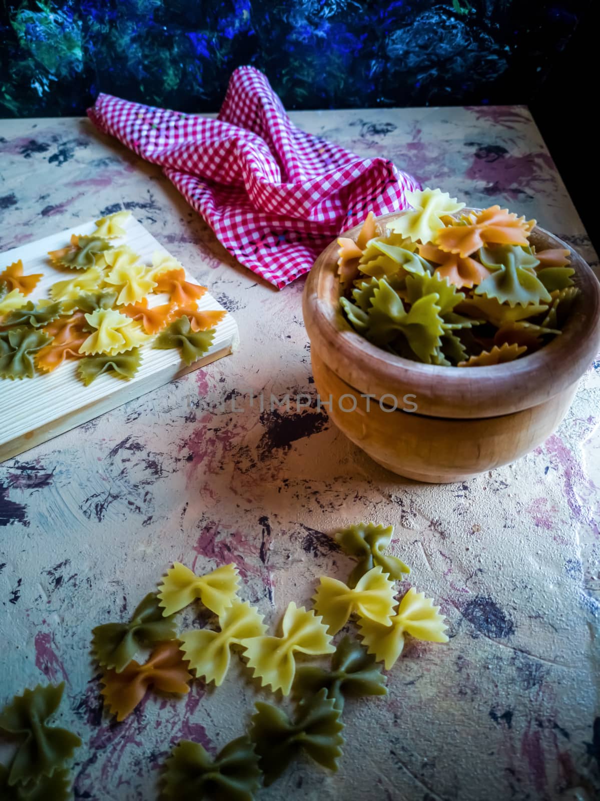 Colorful pasta ties in composition on light and rough background