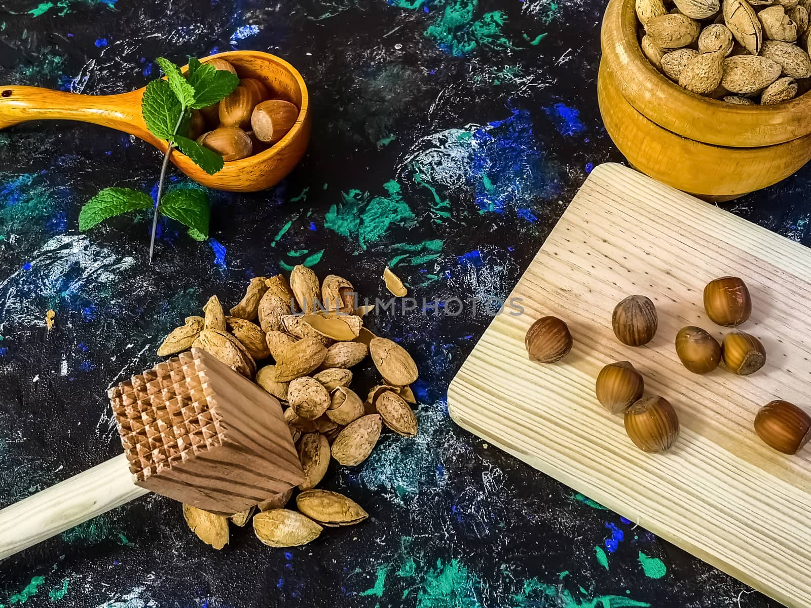 Walnuts and hazelnuts in composition on dark and rough background