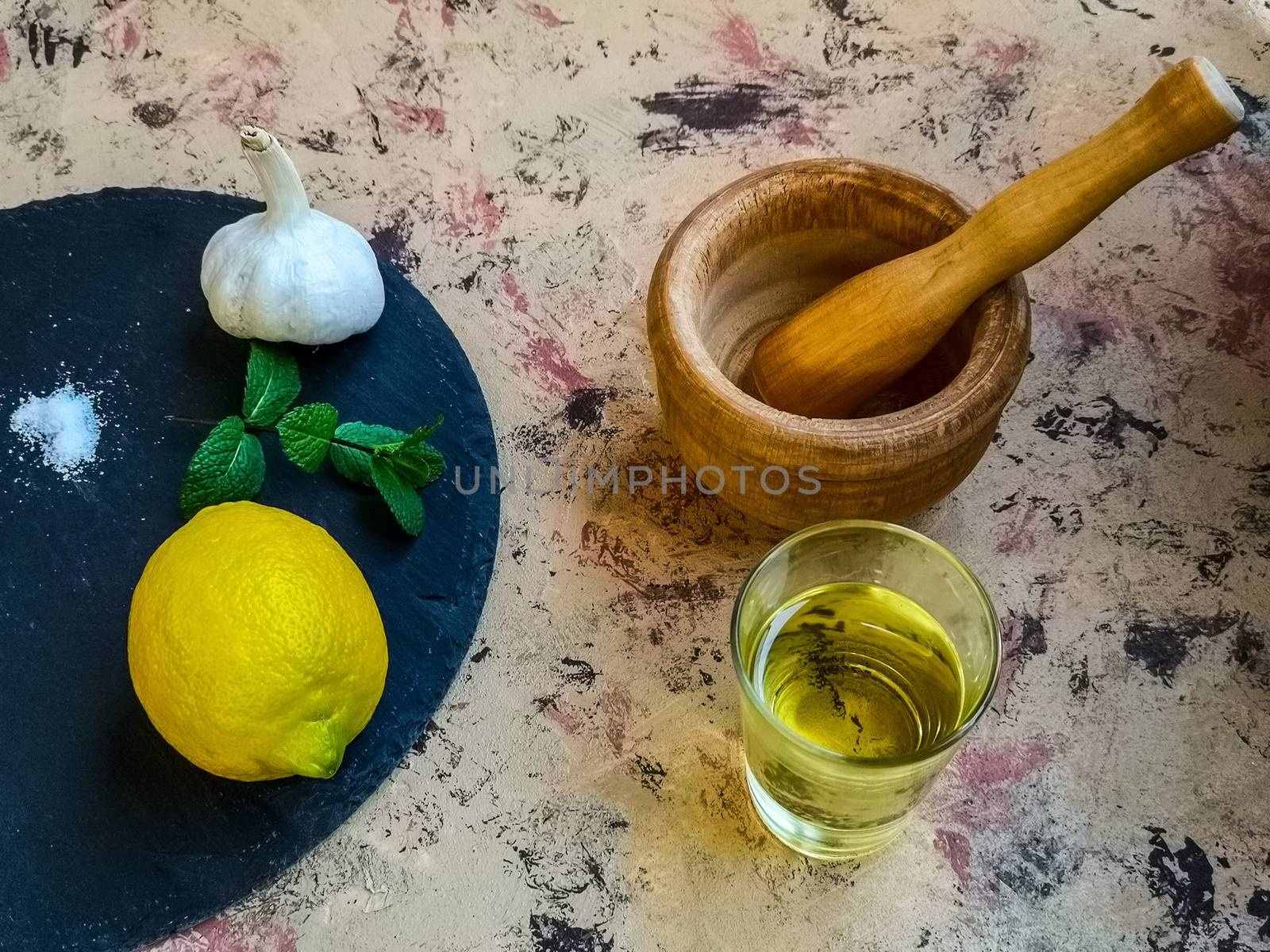 Ingredients and utensils to make mayonnaise with garlic in composition on light background