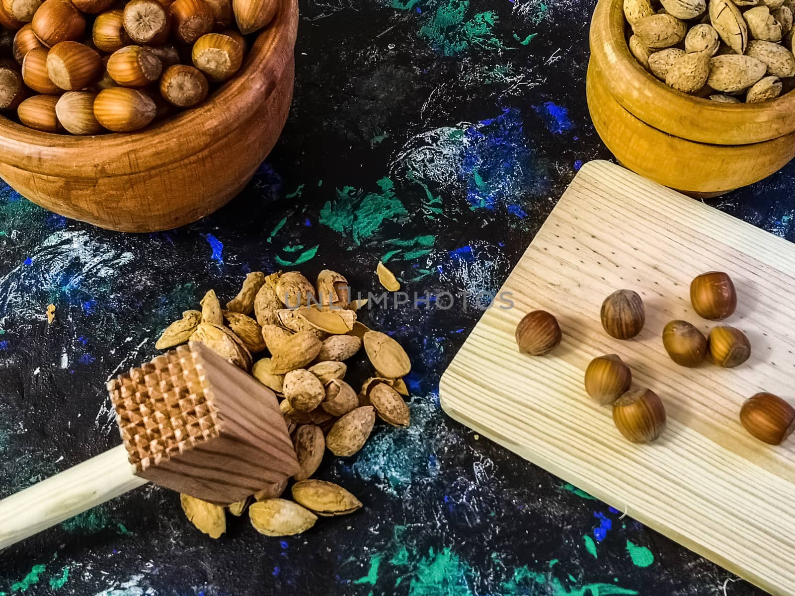 Walnuts and hazelnuts in composition on dark and rough background
