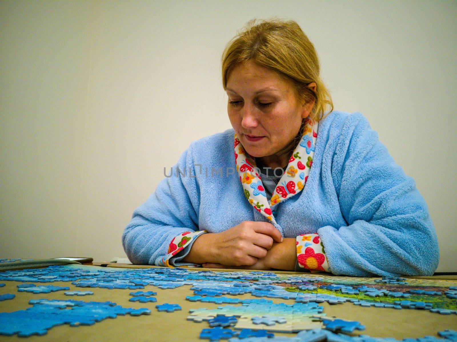 Woman in lab coat making puzzle at home